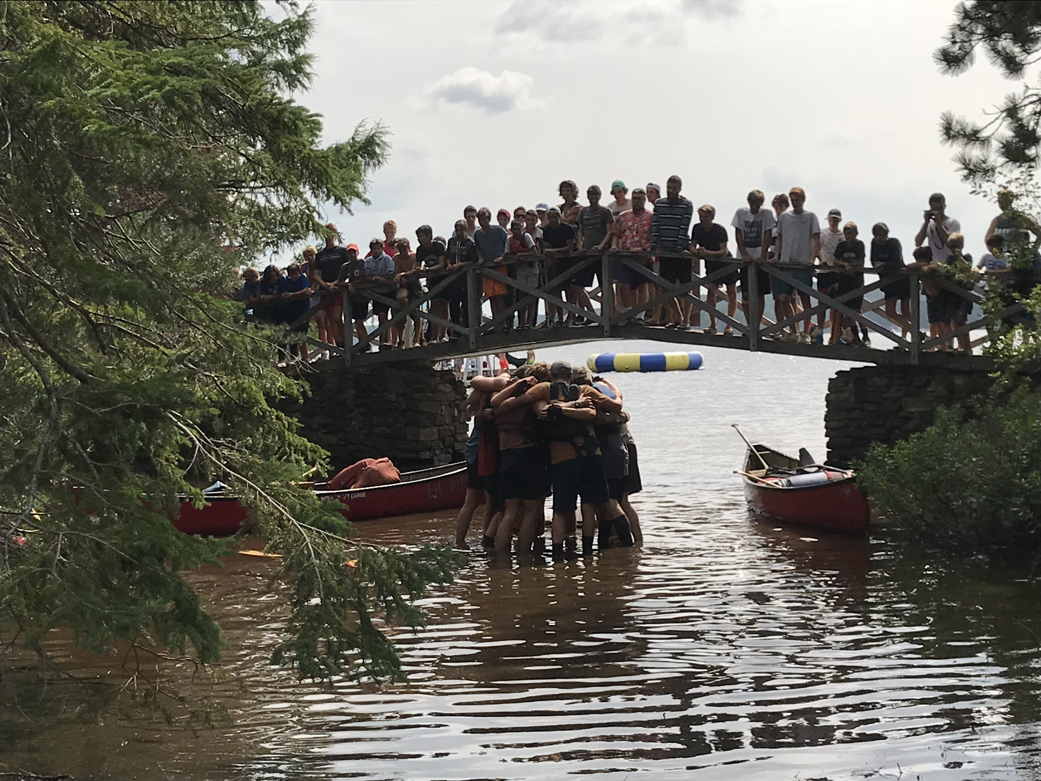 A large group of campers gathered at the waterfront